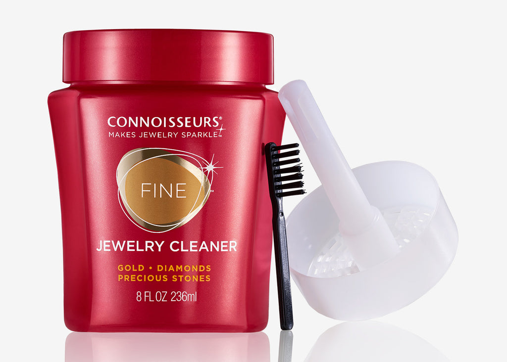 Connoisseurs Fine Jewelry Cleaner in red bottle with brush and dipping basket, shown from front angle.