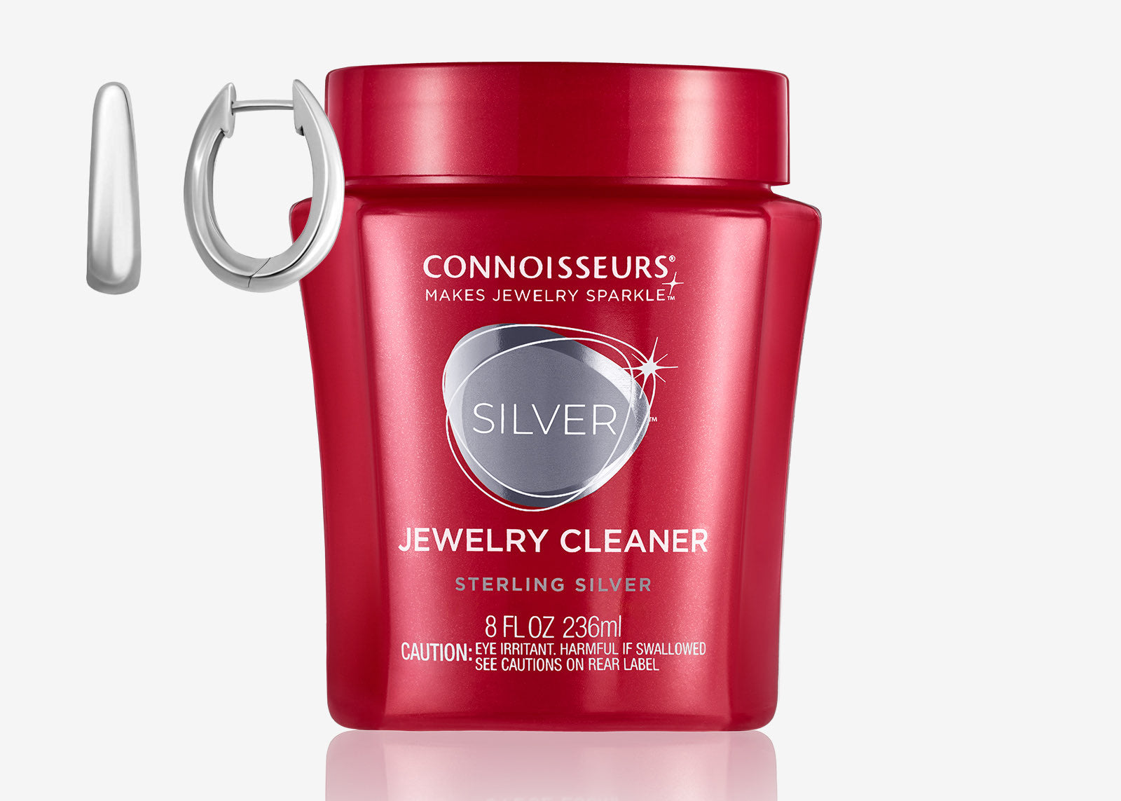 Connoisseurs Sterling Silver Jewelry Cleaner in red container with silver hoop earrings displayed beside it