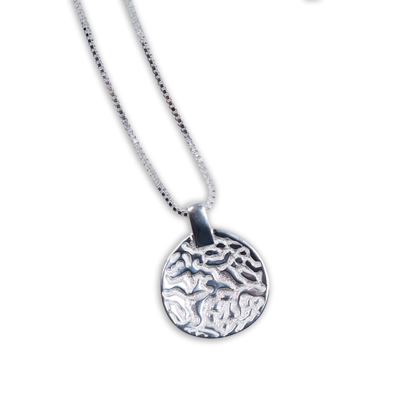 Orion Necklace, a 925 silver necklace with textured circular pendant on ball chain, shown flat lay.