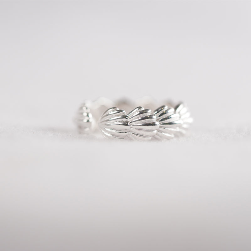 Shiloh Ring, a 925 silver ring with a twisted rope design, shown at an angle on a flat surface.