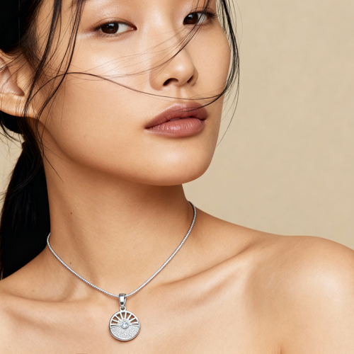 # Rosalie Necklace silver pendant with sunburst design on model wearing silver chain necklace