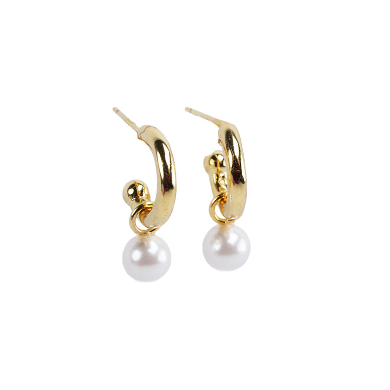Greta Earrings, an 18K gold plated 925 silver earring with curved hoops and white pearl drops, shown from a front angle.