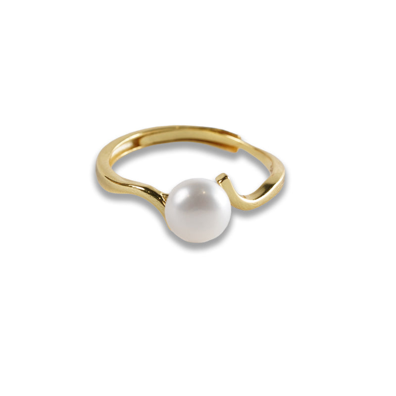 Ebb and Pearl Ring, an 18K gold plated 925 silver ring with a white pearl on a wavy band, shown at an angle.