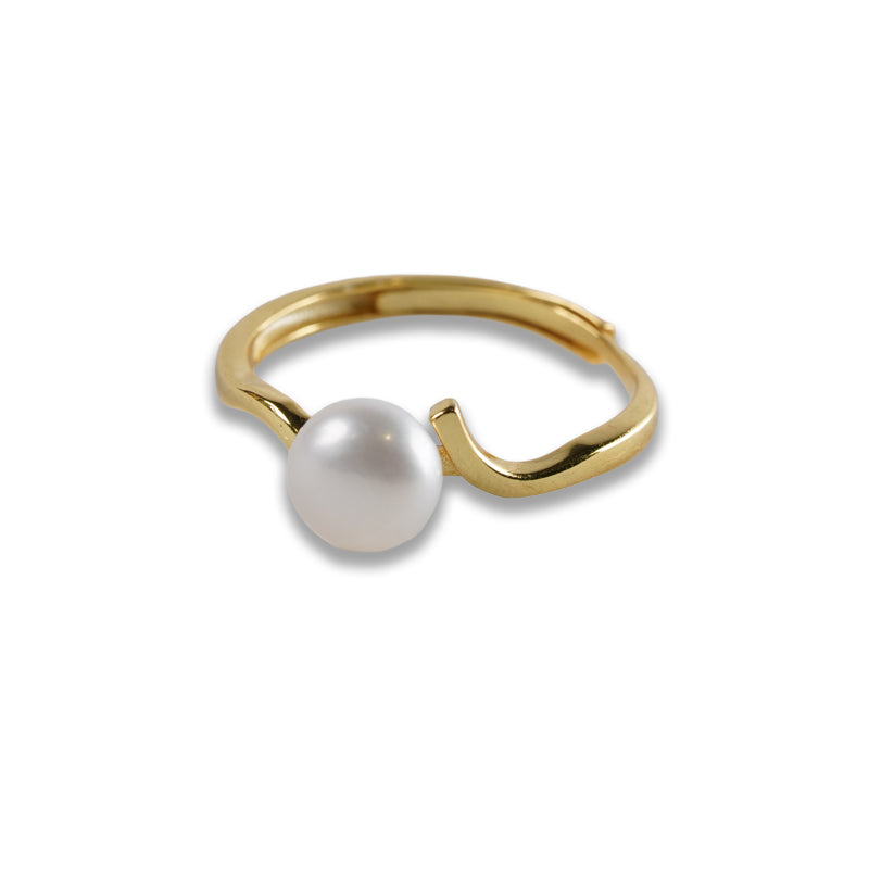Ebb and Pearl Ring, an 18K gold plated 925 silver ring with a white pearl on a wave-shaped band, shown at an angle.