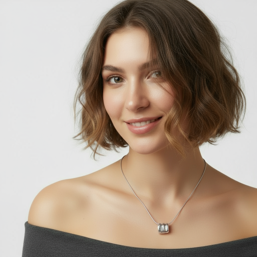 Silver Ripple Necklace, a 925 silver necklace with rectangular rippled pendant, shown on model.