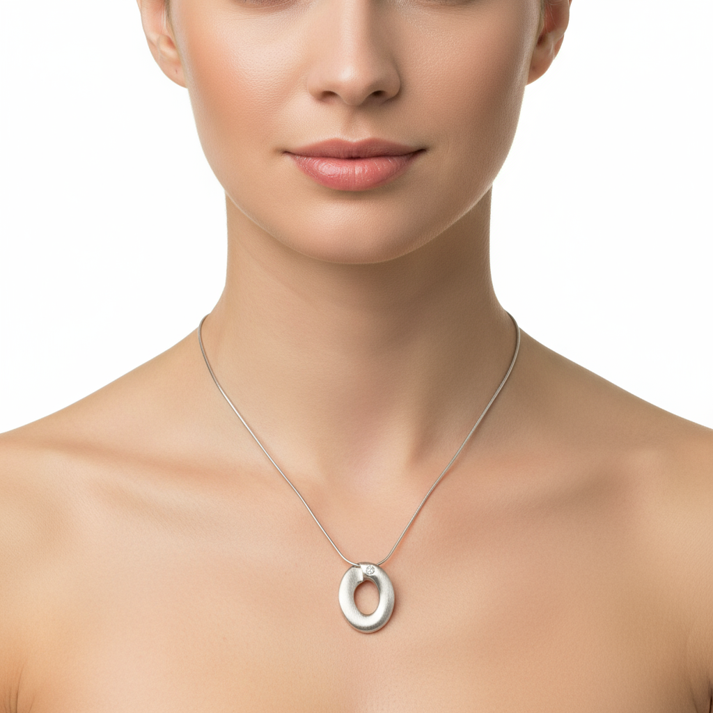 Ophelia Necklace in 925 silver with an oval pendant featuring a hollow center, shown on a model.