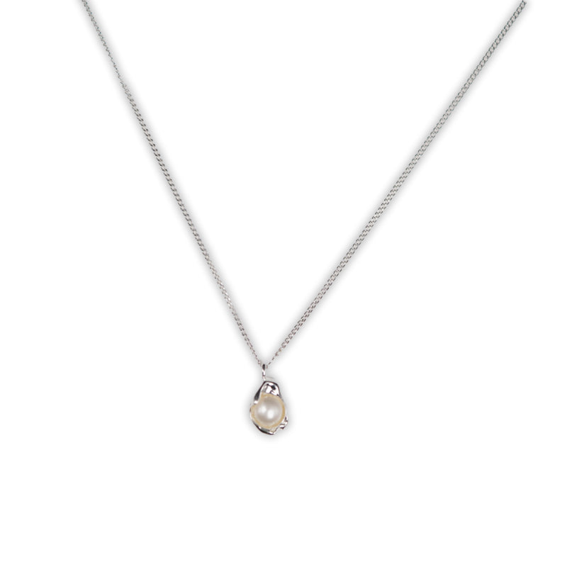 Tide & Pearl Necklace, a 925 silver necklace with a pearl pendant in a wave-shaped setting, shown on a flat lay.