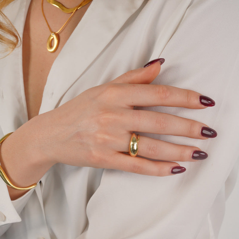 18K Gold plated 925 Silver ring worn on a model's hand, shown against white fabric.