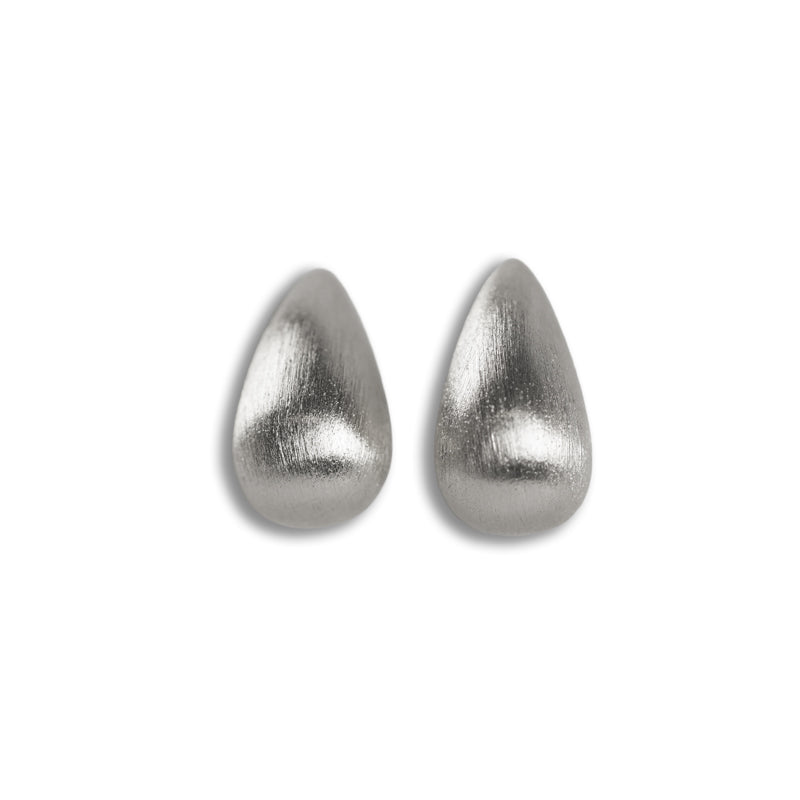 Chiara Earrings- Silver, a pair of 925 silver teardrop-shaped stud earrings, shown from above.