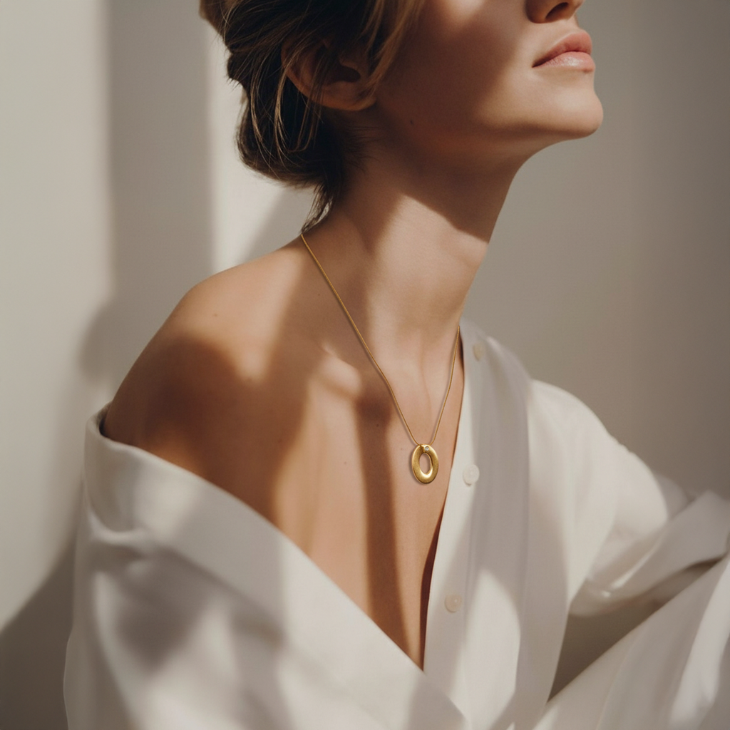 Gold oval locket pendant necklace on woman wearing white shirt - Ophelia Necklace Gold