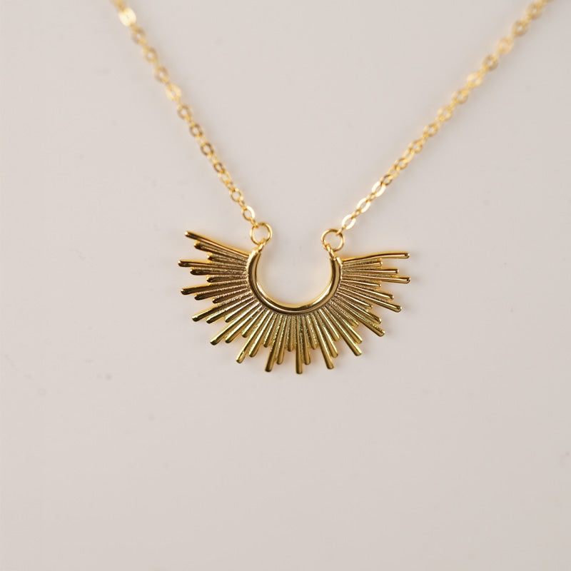Inti Necklace, an 18K gold plated 925 silver necklace with a crescent sunburst pendant, shown on a neutral background.