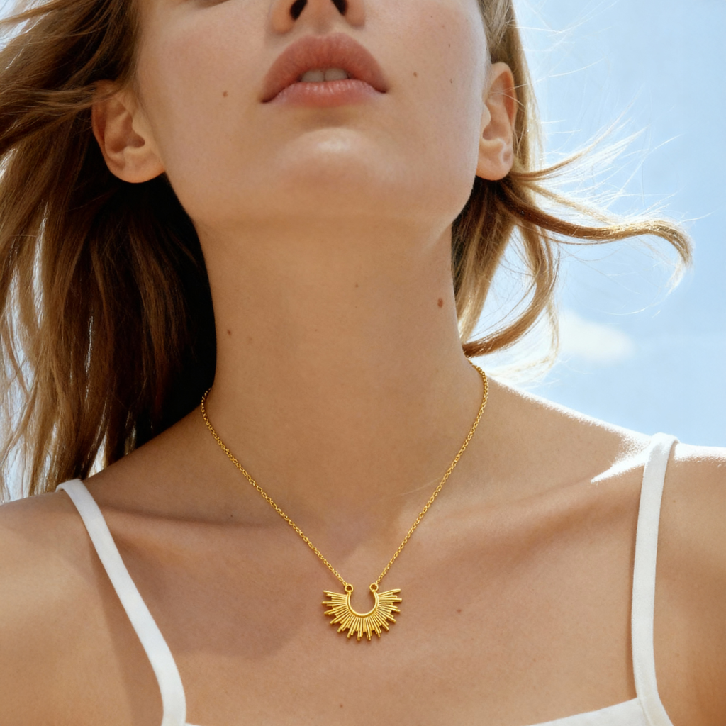 Gold plated Inti Necklace with sunburst pendant on 925 silver chain, worn on model.
